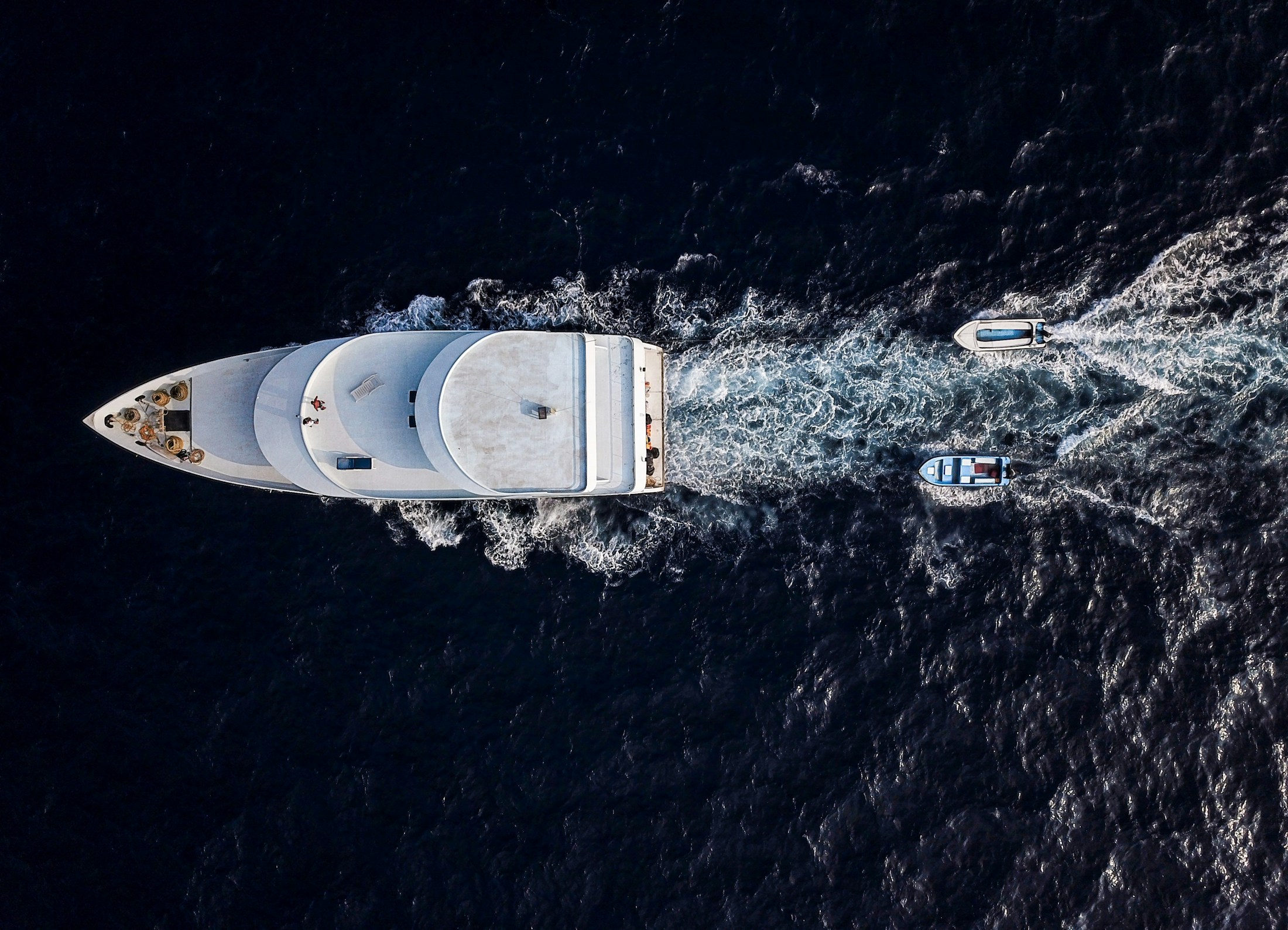 A yacht tracing a path across the open sea